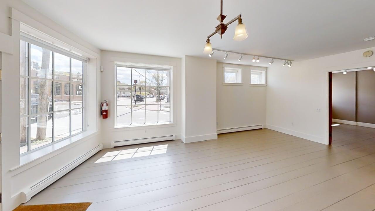 Main retail floor with track lighting and large windows